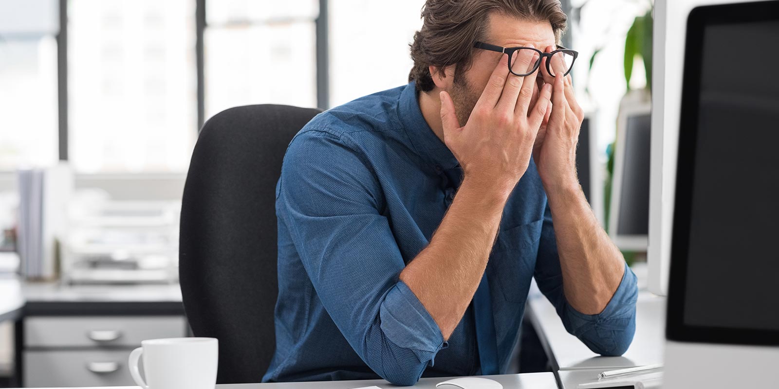 Exasperated Office Worker rubbing eyes